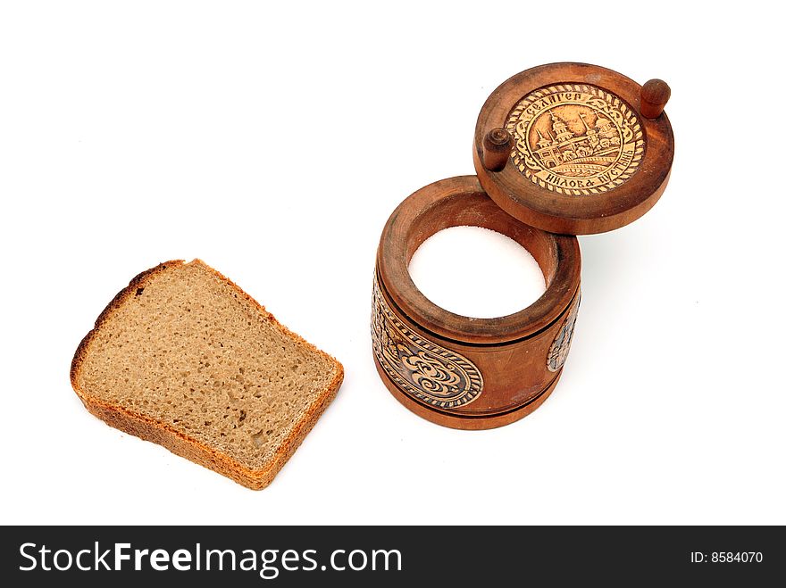 Slice of bread and saltcellar on the white background