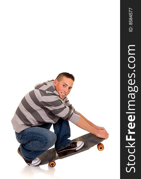 Handsome happy smiling blushing skaterboy dressed in jeans, studio shot. Handsome happy smiling blushing skaterboy dressed in jeans, studio shot