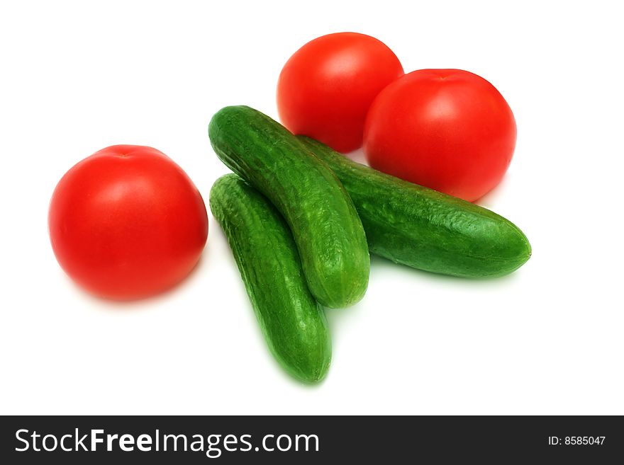 Tomatoes and cucumbers isolated on white. Tomatoes and cucumbers isolated on white.