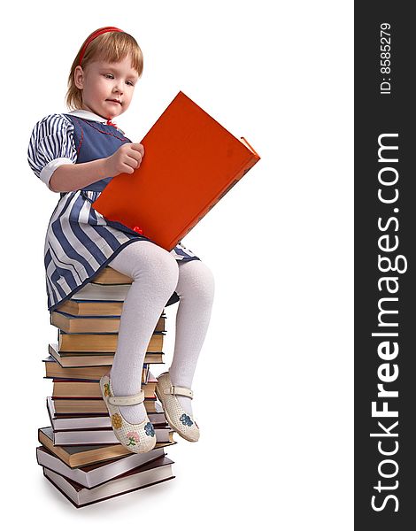 Schoolgirl sitting on the heap of books  on white background