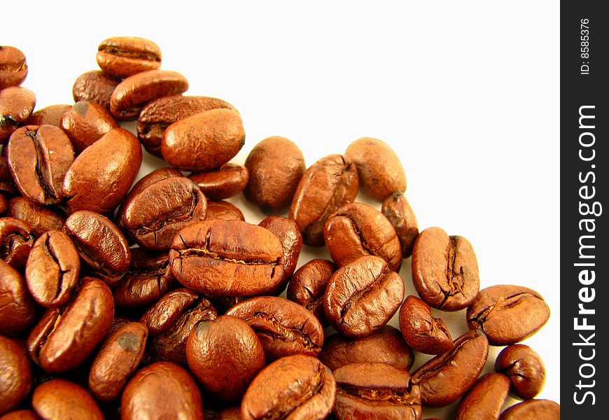 Closeup of whole coffee beans on a white background