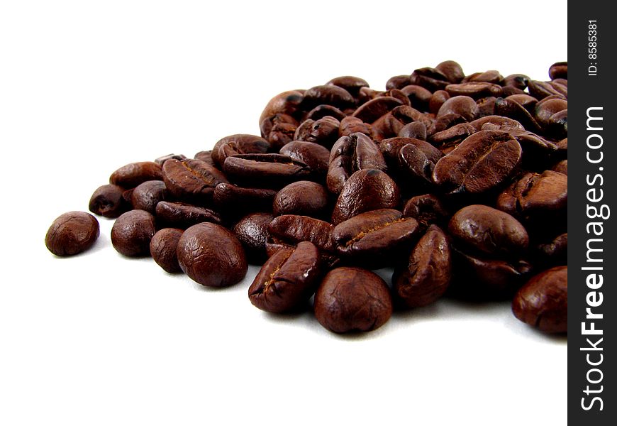 Closeup of whole coffee beans on a white background