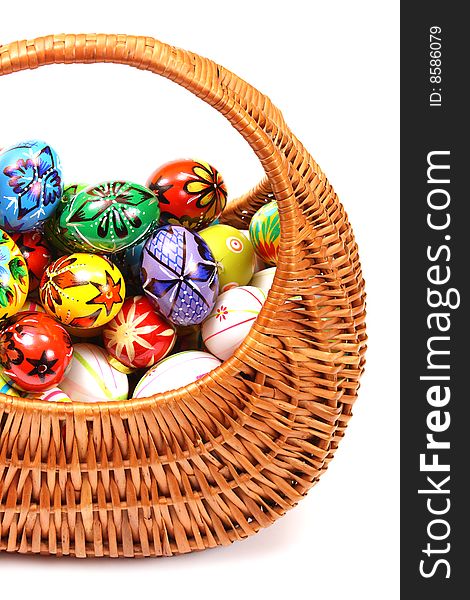 Couple of colorful Easter Eggs in wicker basket.