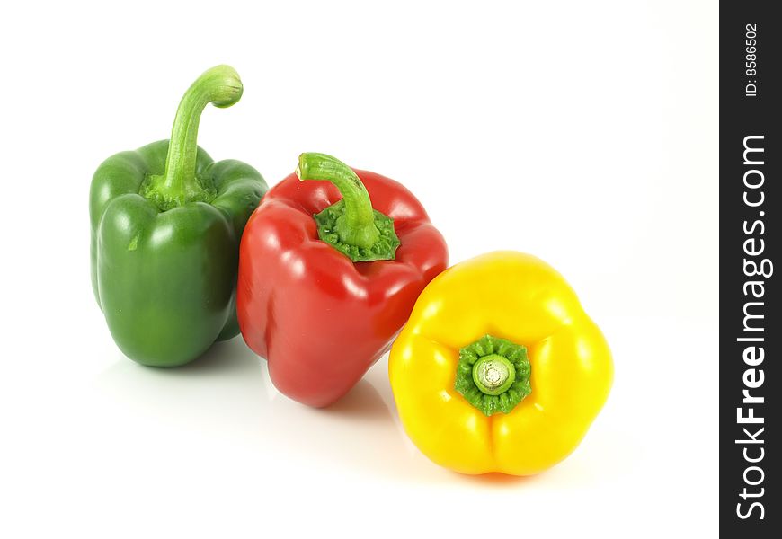 Red, green and yellow bell peppers on white isolated background. Red, green and yellow bell peppers on white isolated background.