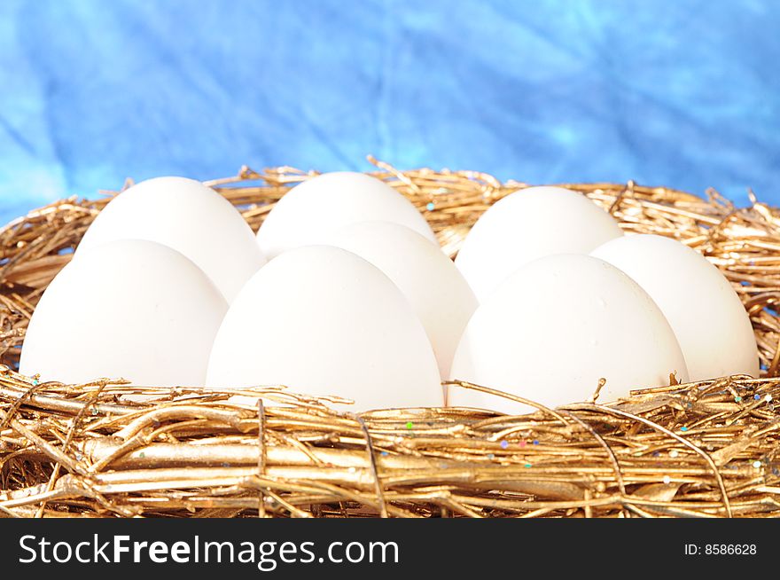 White eggs in golden nest
