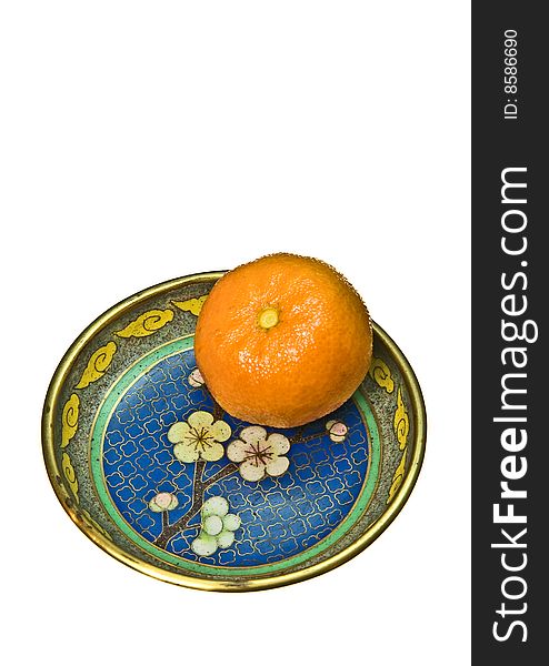 One mandarin on a blue plate, isolated on white background. One mandarin on a blue plate, isolated on white background.