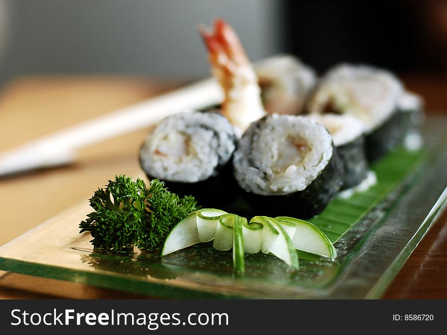 Sushi with prawn on green glass plate. Sushi with prawn on green glass plate