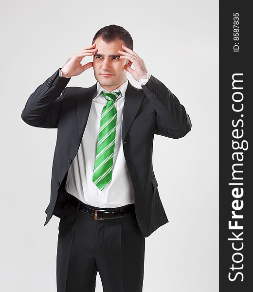 Stressed businessman with his hand to his head. Stressed businessman with his hand to his head