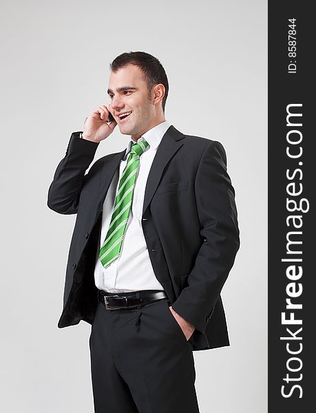 Portrait of a young smiling business man using cell phone. Portrait of a young smiling business man using cell phone