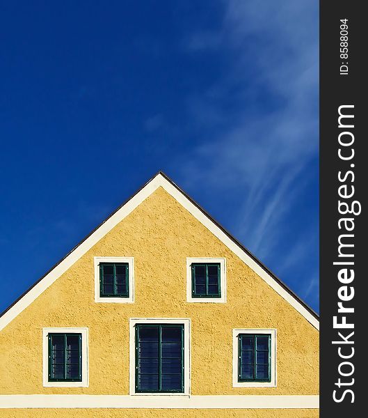 A yellow house, a blue sky. A yellow house, a blue sky