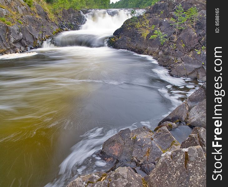 Waterfall and green forest in stones. Waterfall and green forest in stones