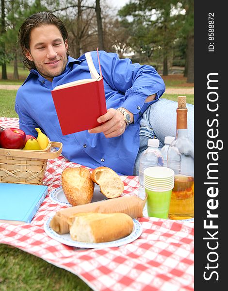 A man reading book in picnic summer day outdoor by himself. A man reading book in picnic summer day outdoor by himself