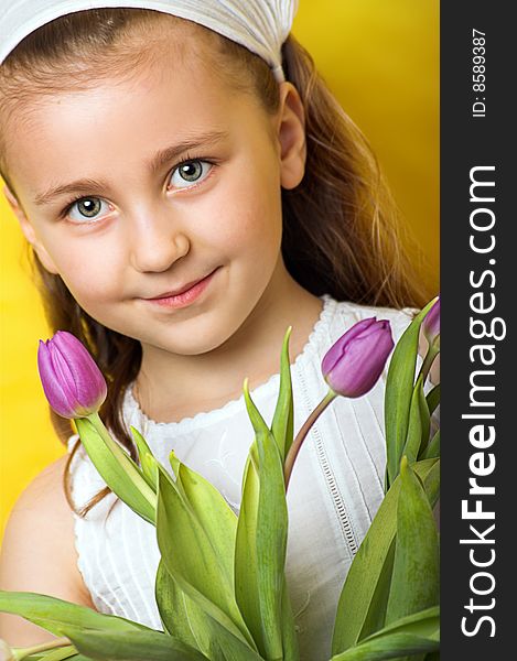 Smiling beautiful young girl with tulips at spring. Smiling beautiful young girl with tulips at spring