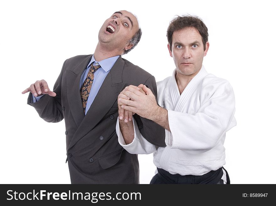 Aikido fighter hurting a businessman (isolated on white). Aikido fighter hurting a businessman (isolated on white)