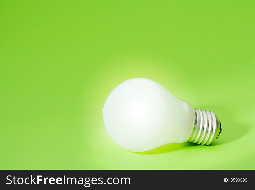 Light bulb on green background