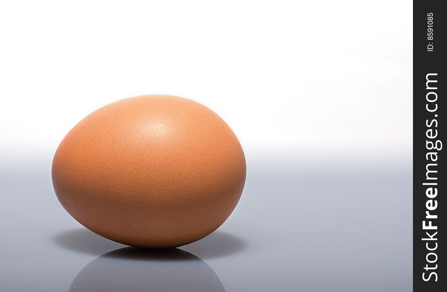 Single egg isolated on left with white upper background. Single egg isolated on left with white upper background
