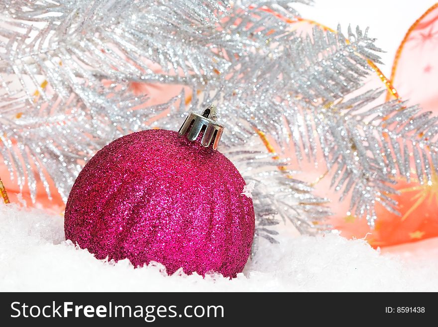 Pink Christmas balls on snow background