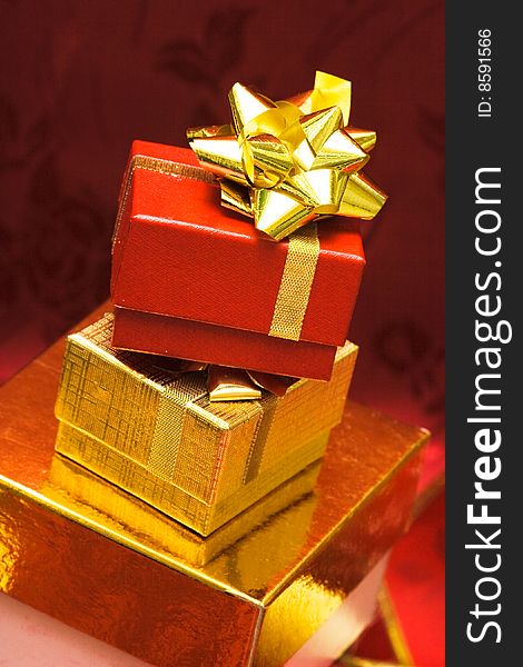 Red and golden gift boxes with bow