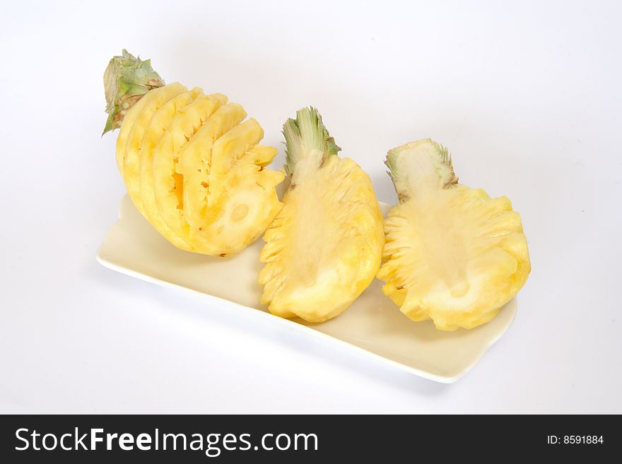 Peeled pineapples, one whole and two halves. Peeled pineapples, one whole and two halves