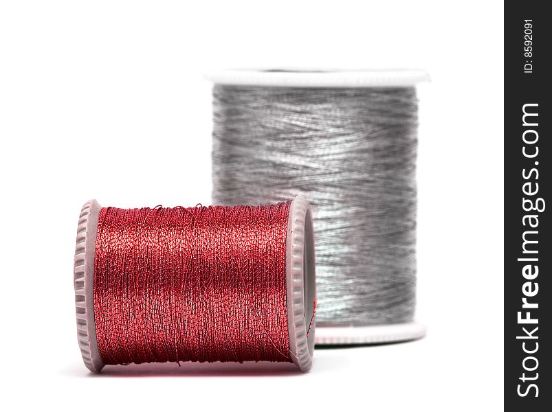 Red and silver spools of threads