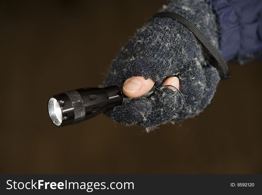 A hand with a lighting electric ttorch  is in night. A hand with a lighting electric ttorch  is in night.
