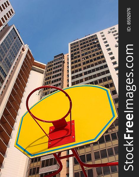 Children's basketball board with ring against high-rise buildings. Children's basketball board with ring against high-rise buildings