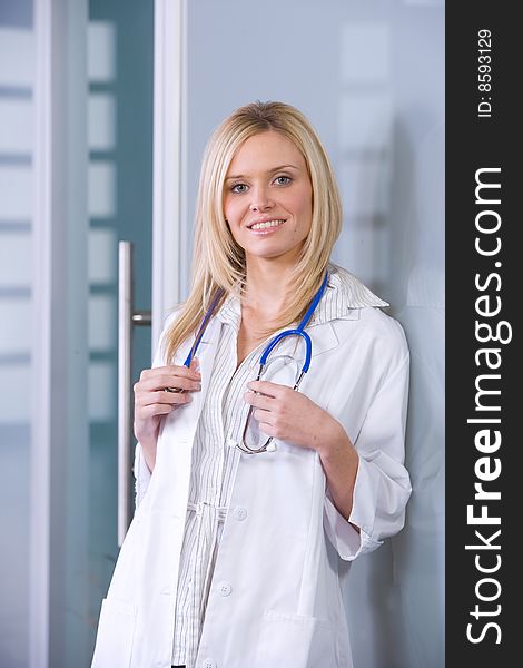 Young female doctor standing in a modern office