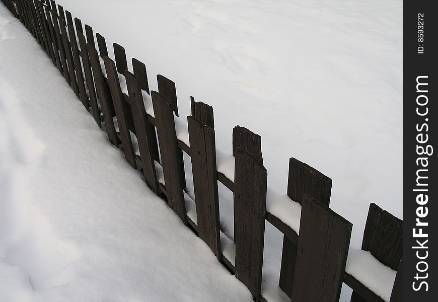 Brown fence in the snow