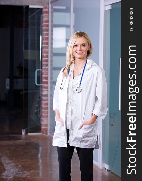 Young female doctor standing in a modern office