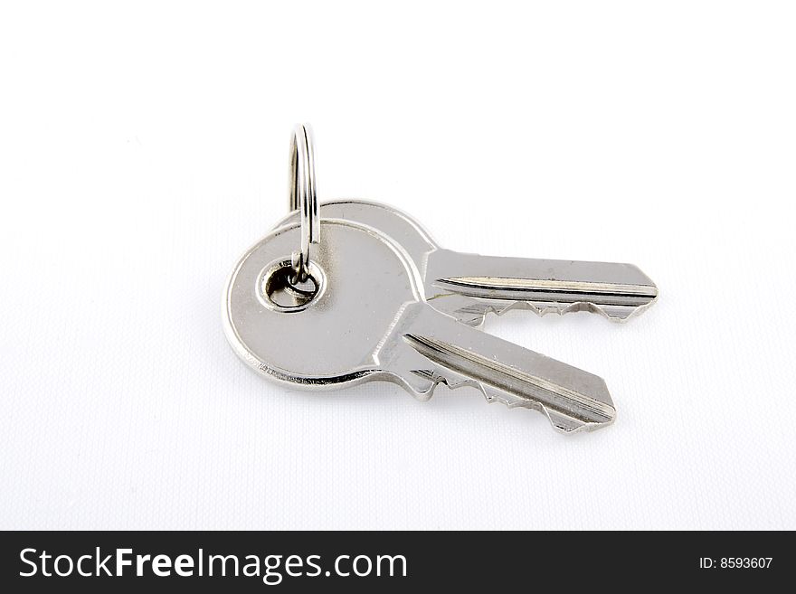 A pair of shiny metal keys held together with a simple key ring