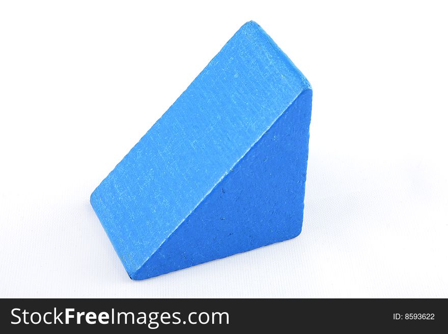 A wooden prism shaped blue toy brick. A wooden prism shaped blue toy brick