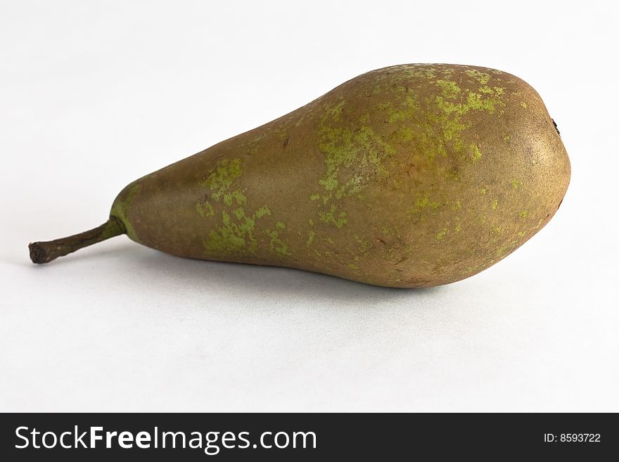 A juicy green conference pear against a white background