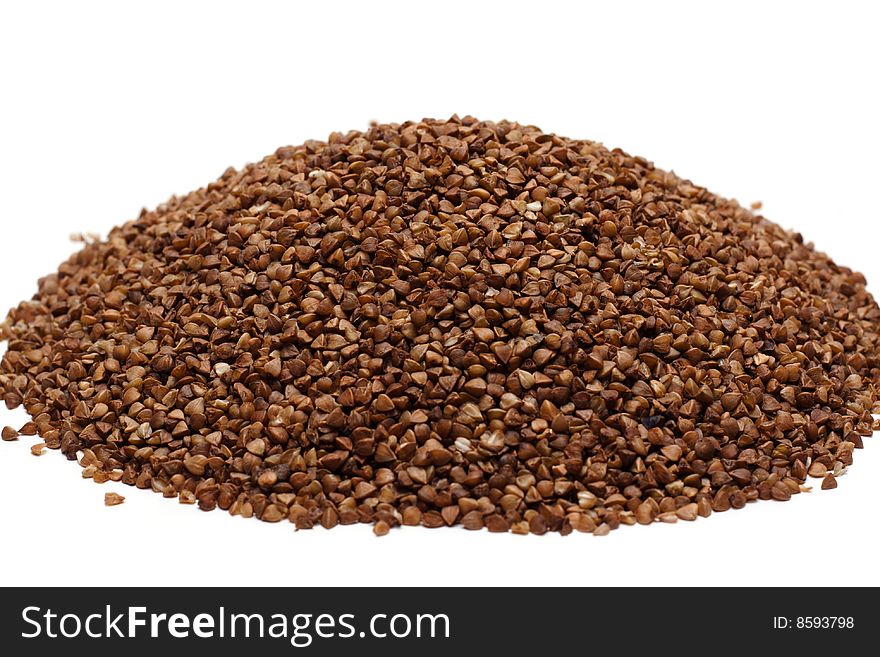 Heap buckwheat croups, disposit on white background. Heap buckwheat croups, disposit on white background