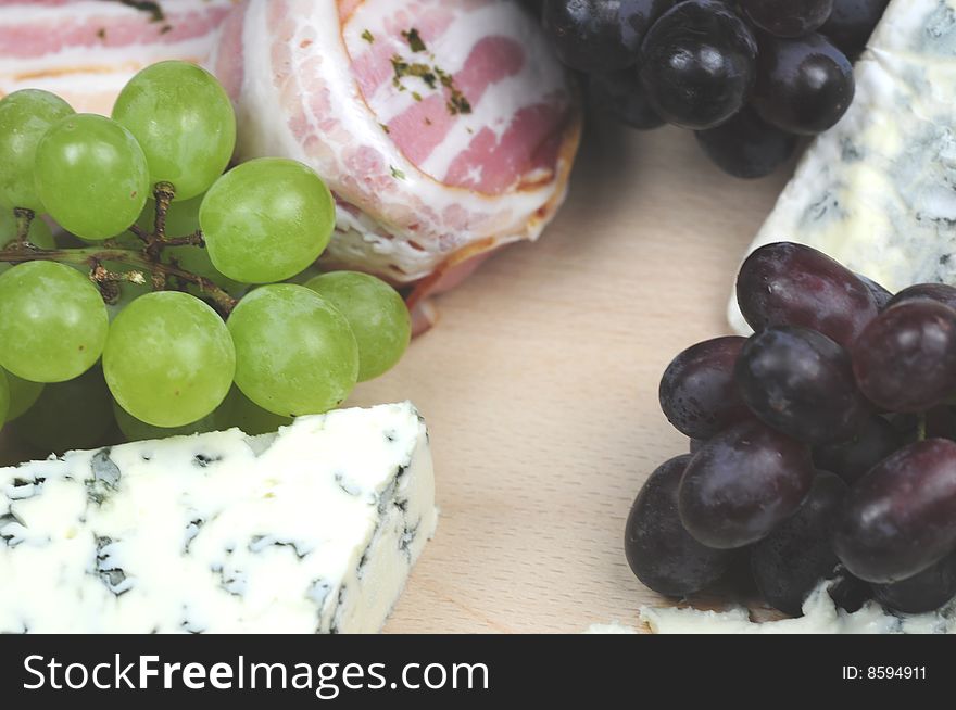 Some delicious French cheeses and some grapes. Some delicious French cheeses and some grapes