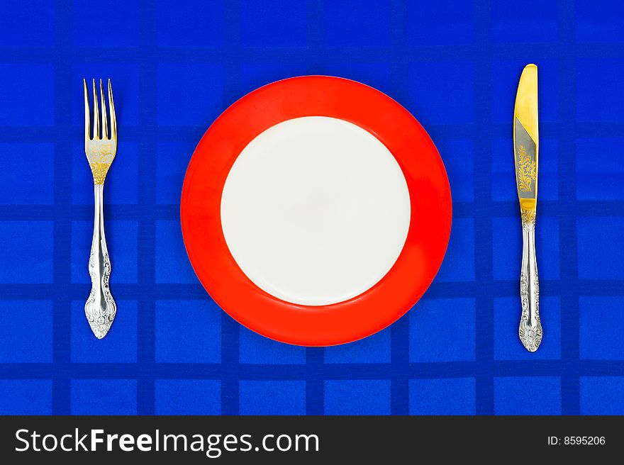 Plate, Knife And Fork On Table Cloth