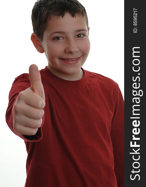 Young boy smiling, with thumb up, focus on his face isolated on white. Young boy smiling, with thumb up, focus on his face isolated on white