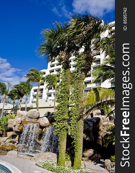 Palm trees and fountains around a luxury hotel property. Palm trees and fountains around a luxury hotel property