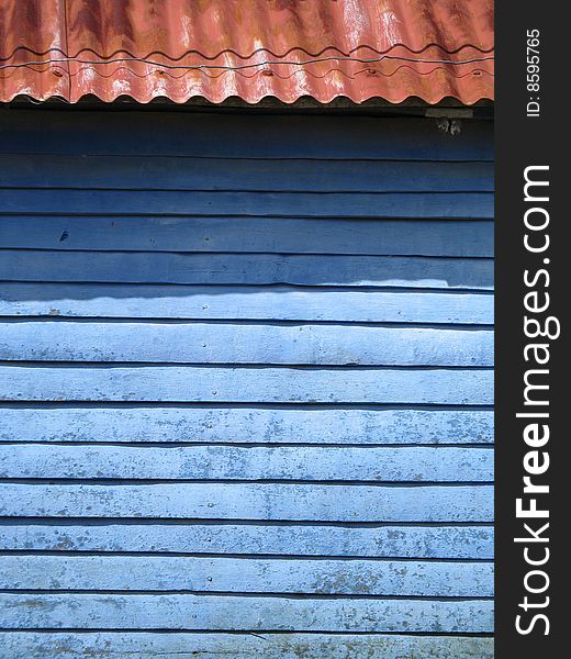 Blue wall and rusty roof