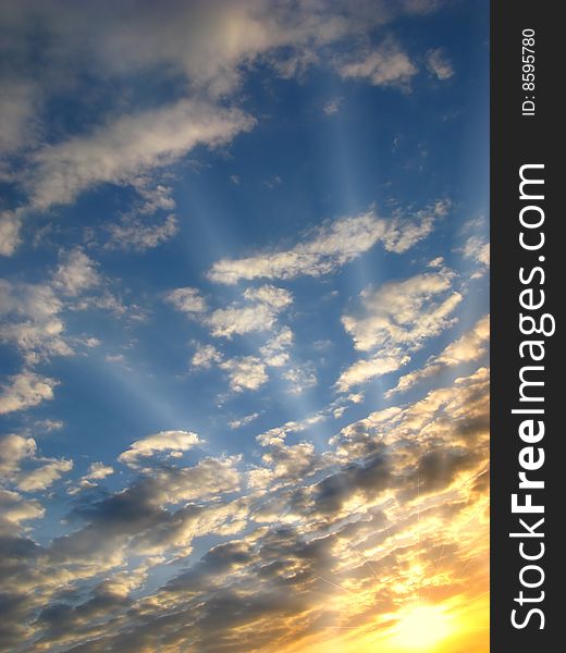 Bright sunset on  background of clouds with solar beams