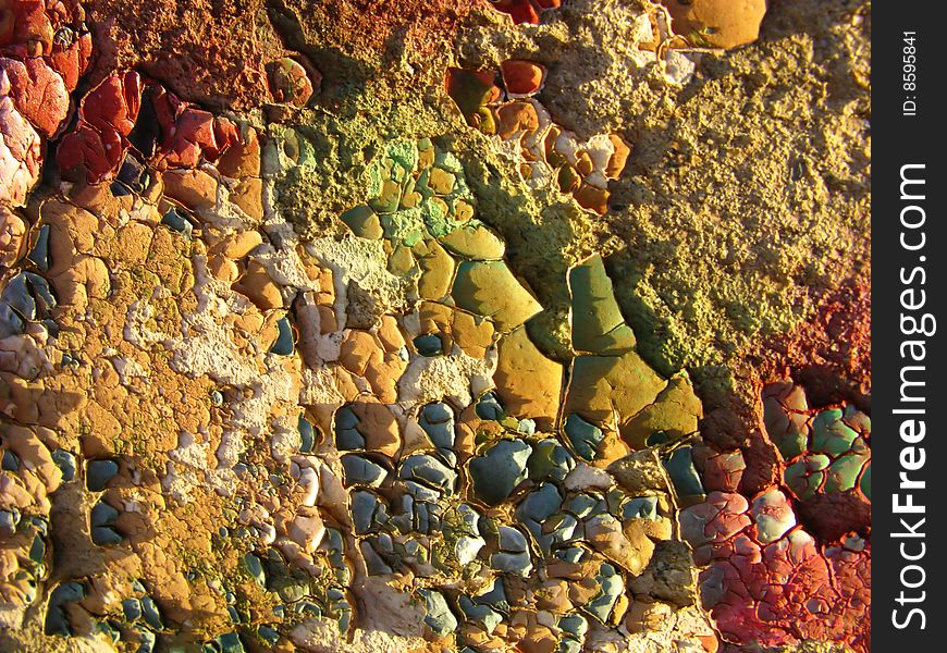 Paint and stones, old wall from various building materials. Paint and stones, old wall from various building materials