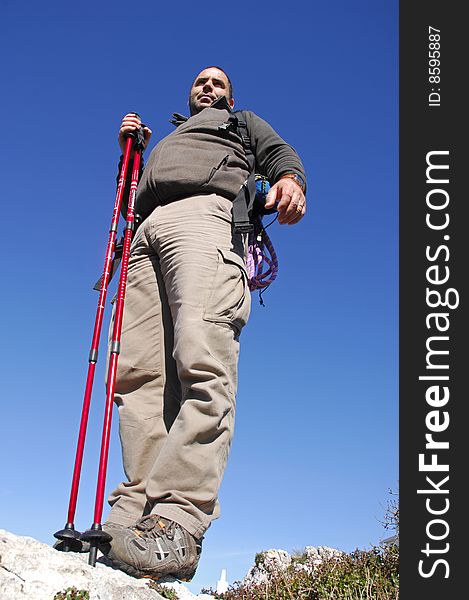 Man in a top of a in mountain hiking