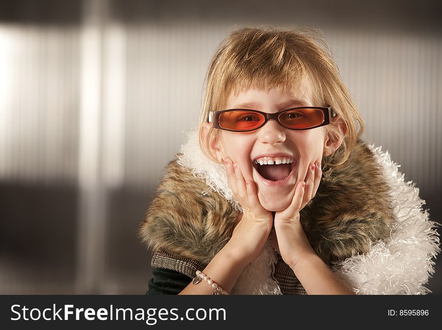 Cute young girl in dress-up clothes and red sunglasses. Cute young girl in dress-up clothes and red sunglasses