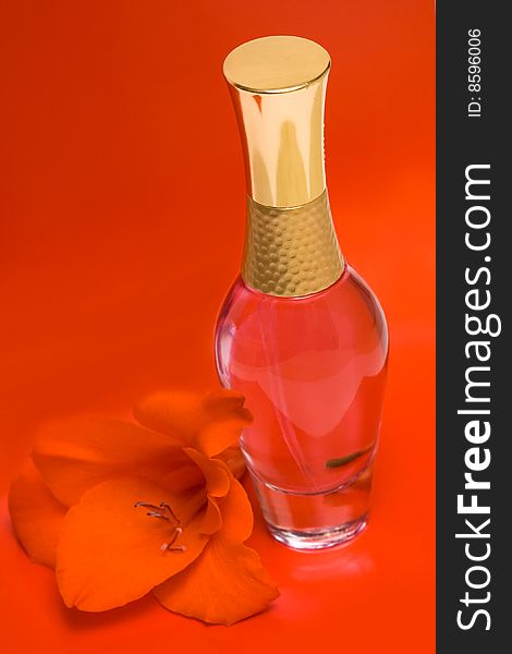Beautiful bottle of perfume with flower