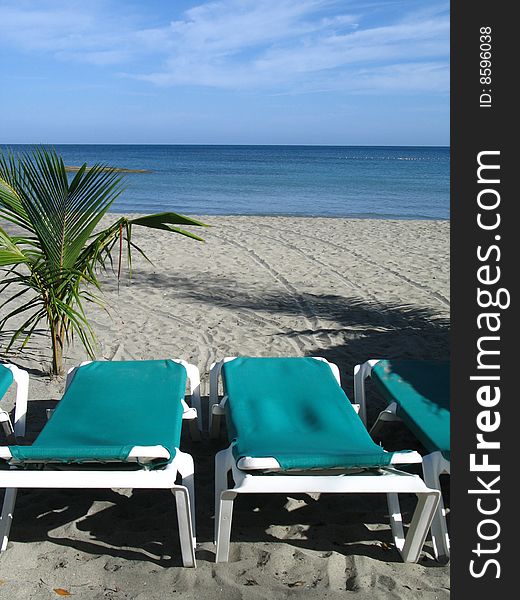 Green chairs on a tropical beach. Green chairs on a tropical beach