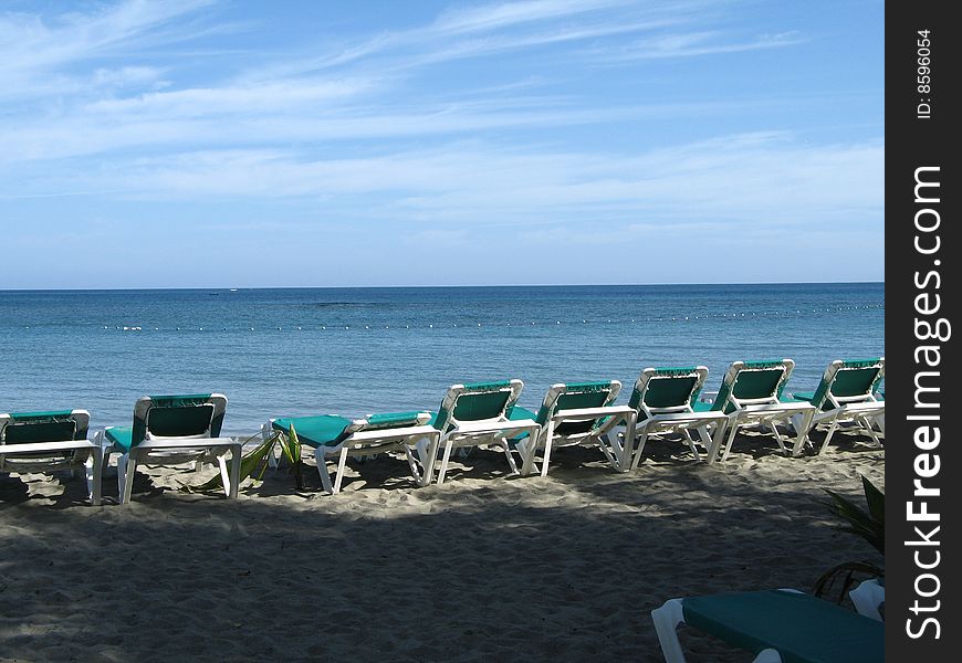 Green chairs on a tropical beach. Green chairs on a tropical beach