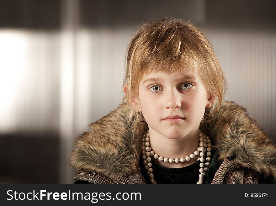 Cute young girl with big eyes in dress-up clothes