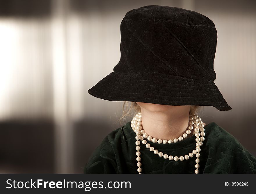 Funny young girl with her face hidden in her hat. Funny young girl with her face hidden in her hat