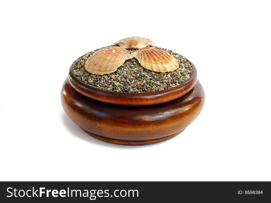 Round wooden box with sea shells on the lid isolated on white. Round wooden box with sea shells on the lid isolated on white