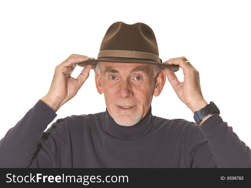 Senior man adjusting his hat ready to go out