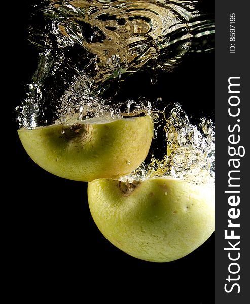 Apple in water on a black background